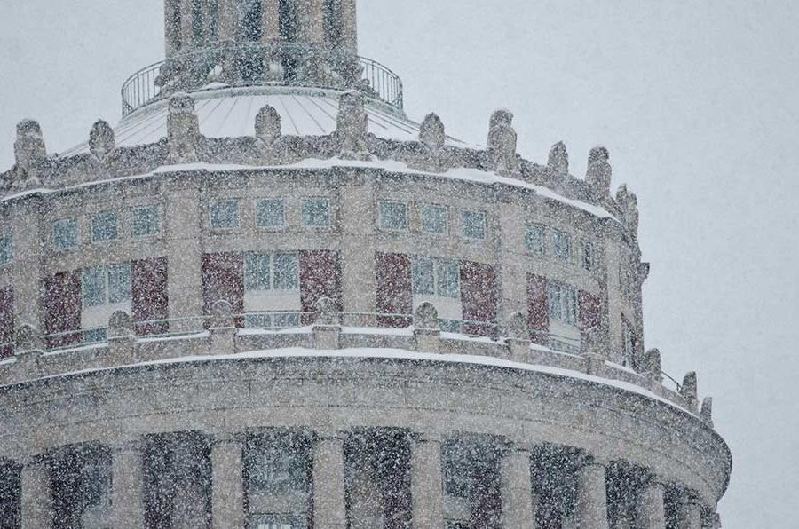 Snow falling in front of University of Rochester Rush Rhees Library